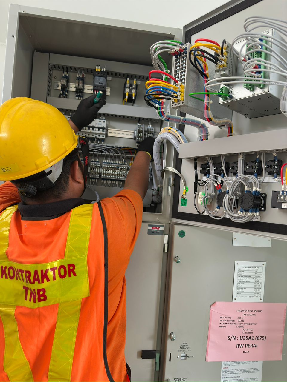 NIKKISO-AYSHA technician testing and commissioning an EPE switchgear panel in Perai, Penang